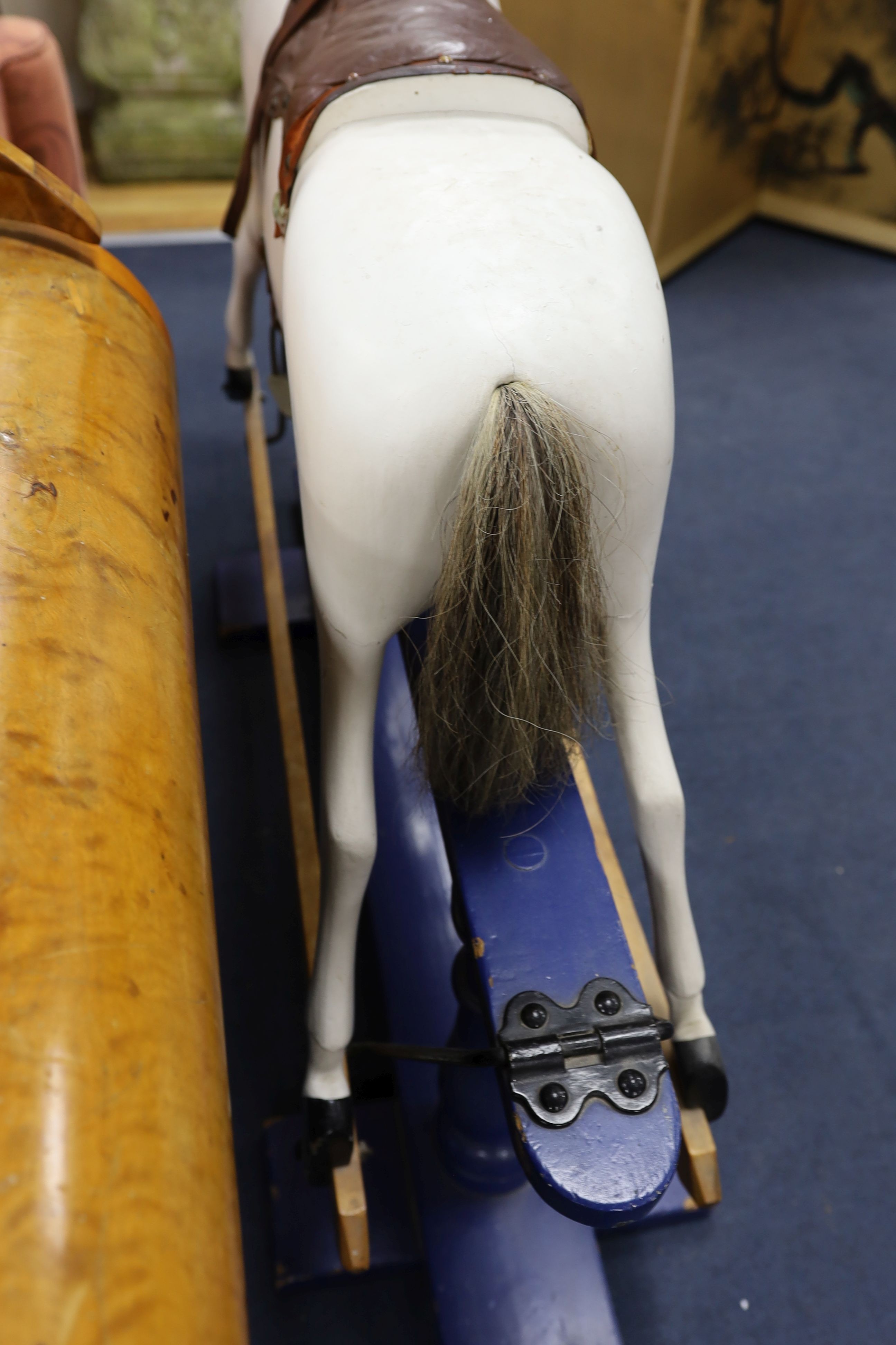 An early 20th century rocking horse on painted safety frame, (re-painted) width 126cm, height 114cm